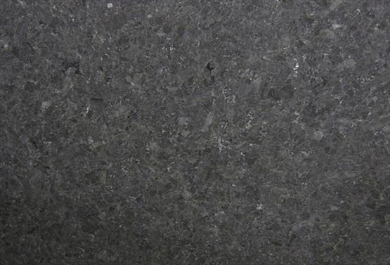 A close-up view of a dark charcoal-gray stone countertop surface with a speckled, granite-like texture.