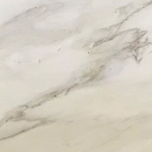 A white marble surface with soft, flowing grey veining throughout.