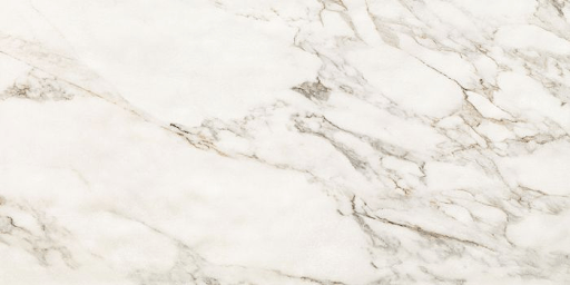 A white marble surface with light grey and brown veining throughout the stone.