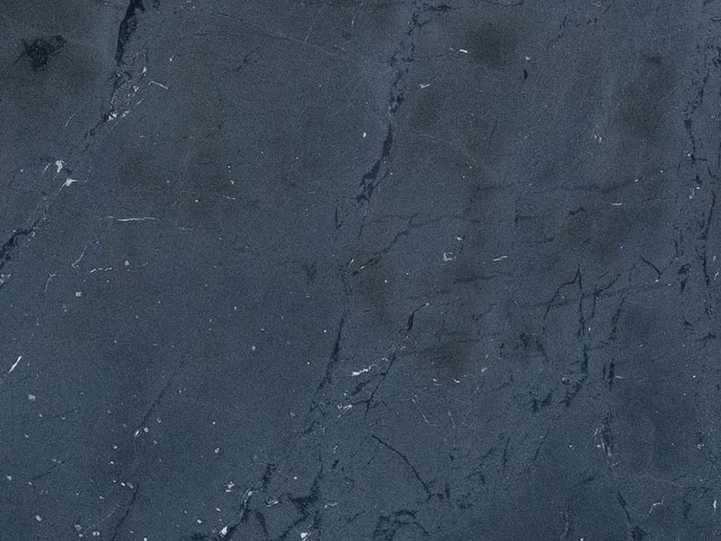 Dark blue marble surface with subtle black veining and occasional white flecks.