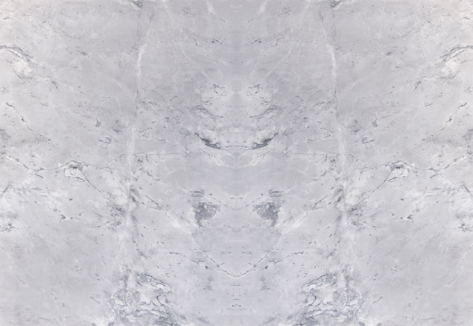 A light gray marble stone texture with subtle white veins and a symmetrical pattern.