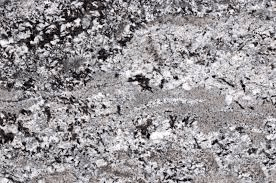 A high-resolution close-up texture of granite stone with a speckled pattern of black, white, and grey mineral flecks.