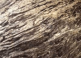An abstract close-up of a marble surface featuring swirling, organic patterns of dark brown, black, and cream.