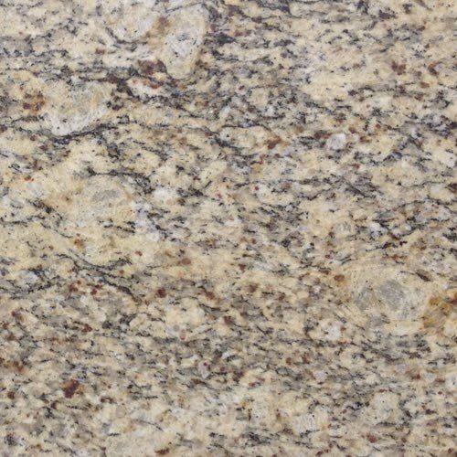 A close-up view of granite with speckled patterns in shades of beige, tan, cream, gray, and dark brown.