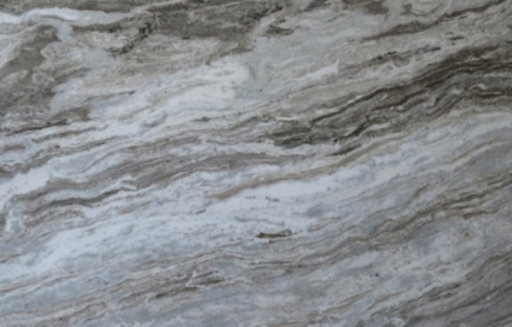 Close-up of polished marble featuring swirling patterns of white, gray, and dark brown veining.