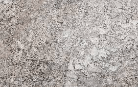 A close-up of speckled granite countertop with a mixture of grey, white, and black stone flecks.