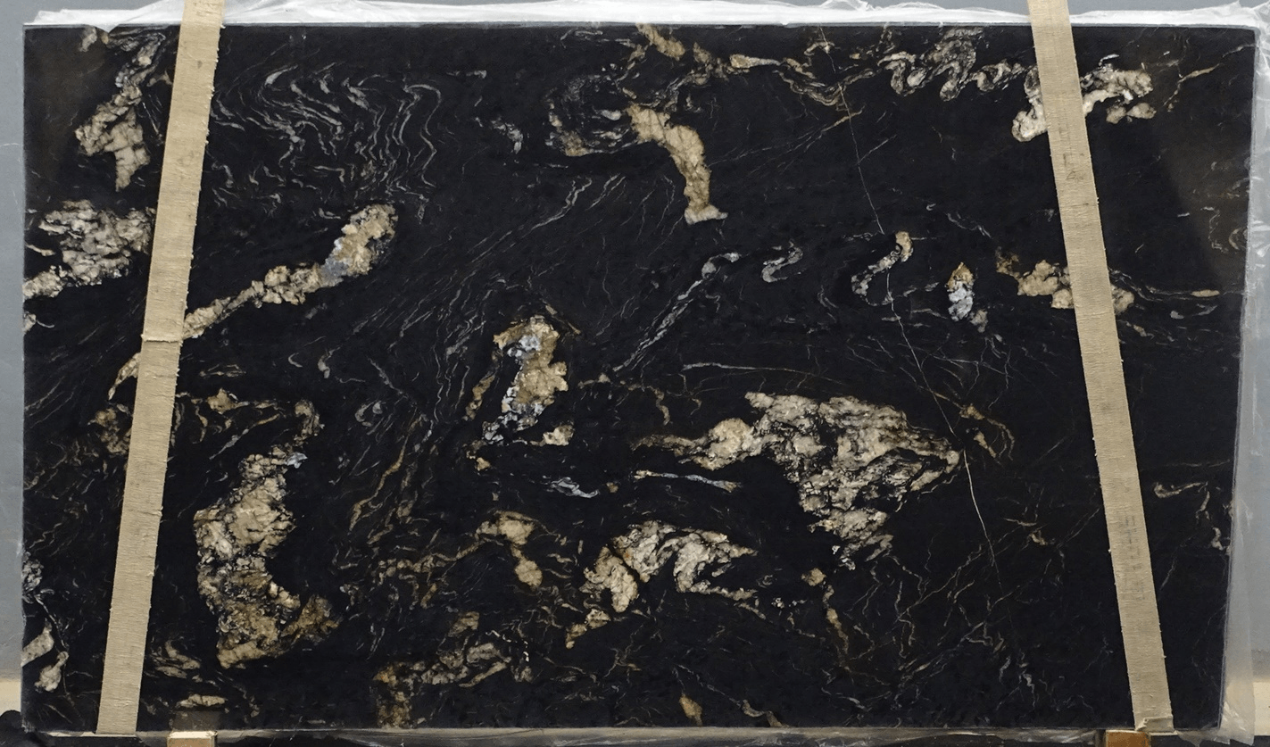 A slab of polished black granite featuring irregular gold and white veining held by two vertical straps.