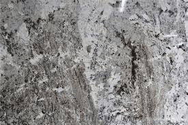 Close-up of a granite surface with a mottled pattern of black, gray, and white mineral flecks and veins.