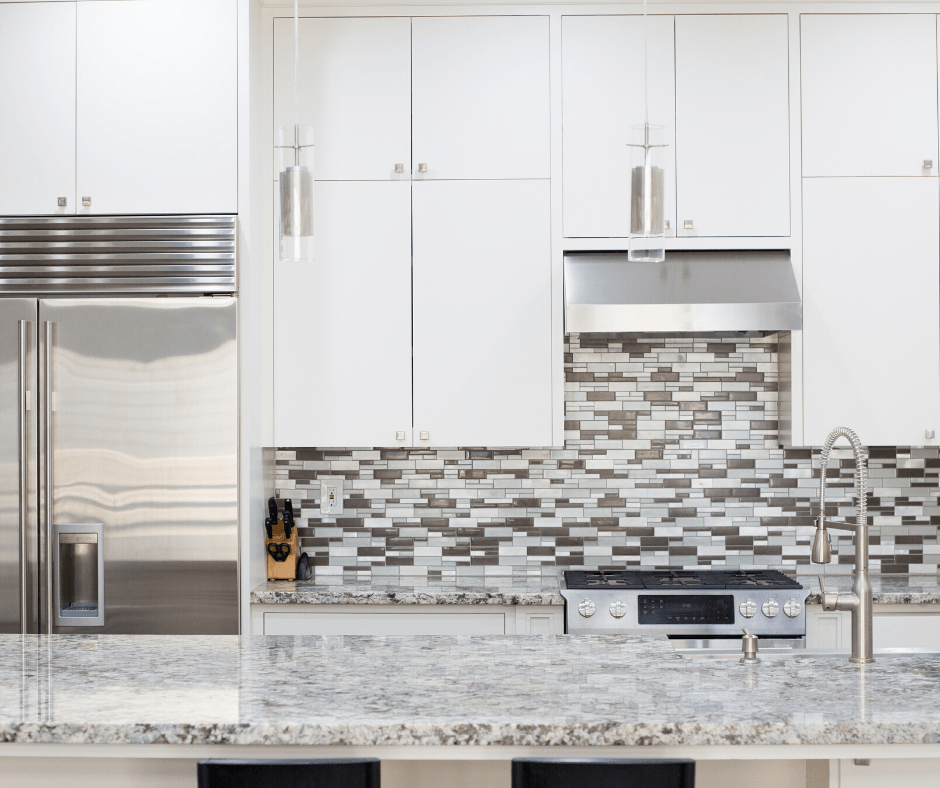 A modern kitchen features white cabinets, stainless steel appliances, a tiled backsplash, and a granite countertop.