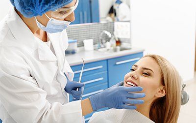 Teeth Extraction — Dentist Checking Patient's Teeth in New Orleans, LA Teeth Extraction — Dentist Checking Patient's Teeth in New Orleans, LA