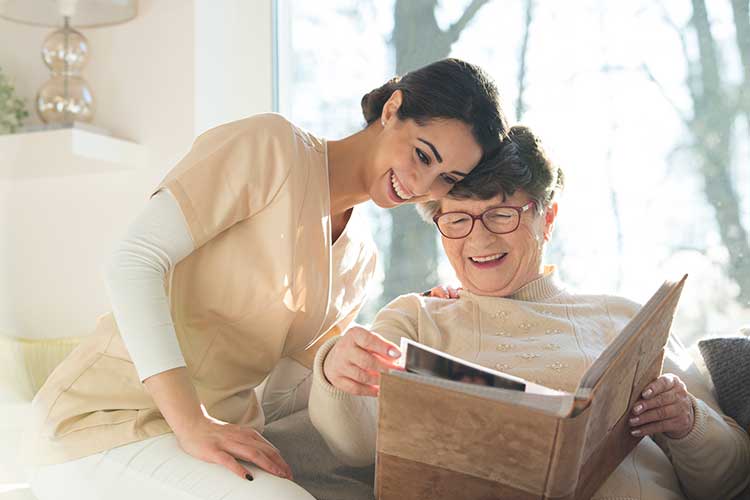 Seniors Woman and Caregiver Checking the Photobook — Uniontown, PA — Pento Homecare Agency