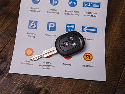 Driving Lessons For 16 Year Olds — Closeup Of Road Signs And Car Keys in Mine Hill, NJ