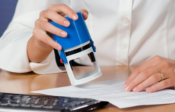 Businessman Puts a Stamp on The Contract — Nationwide — Notary Privacy Guards® Businessman Puts a Stamp on The Contract — Nationwide — Notary Privacy Guards®