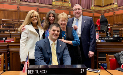 Gary Turco being sworn in as Newington's State Representative Former State Rep. Sandy Nafis, Councilmember Carol Anest, Democratic Town Chairman John Kelly, and Community Activist Terri LaPenta-Duffek