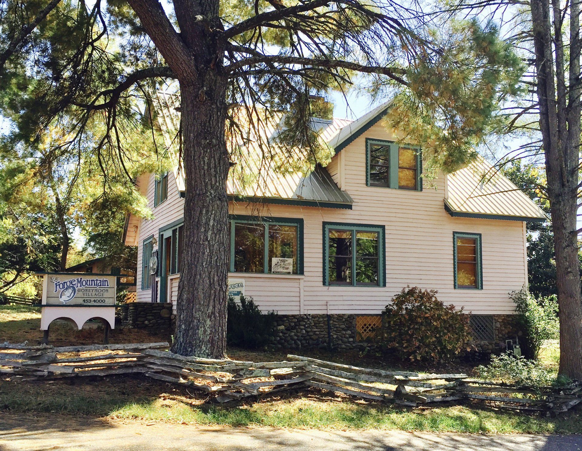 A white house with a sign that says ' lodge ' on it