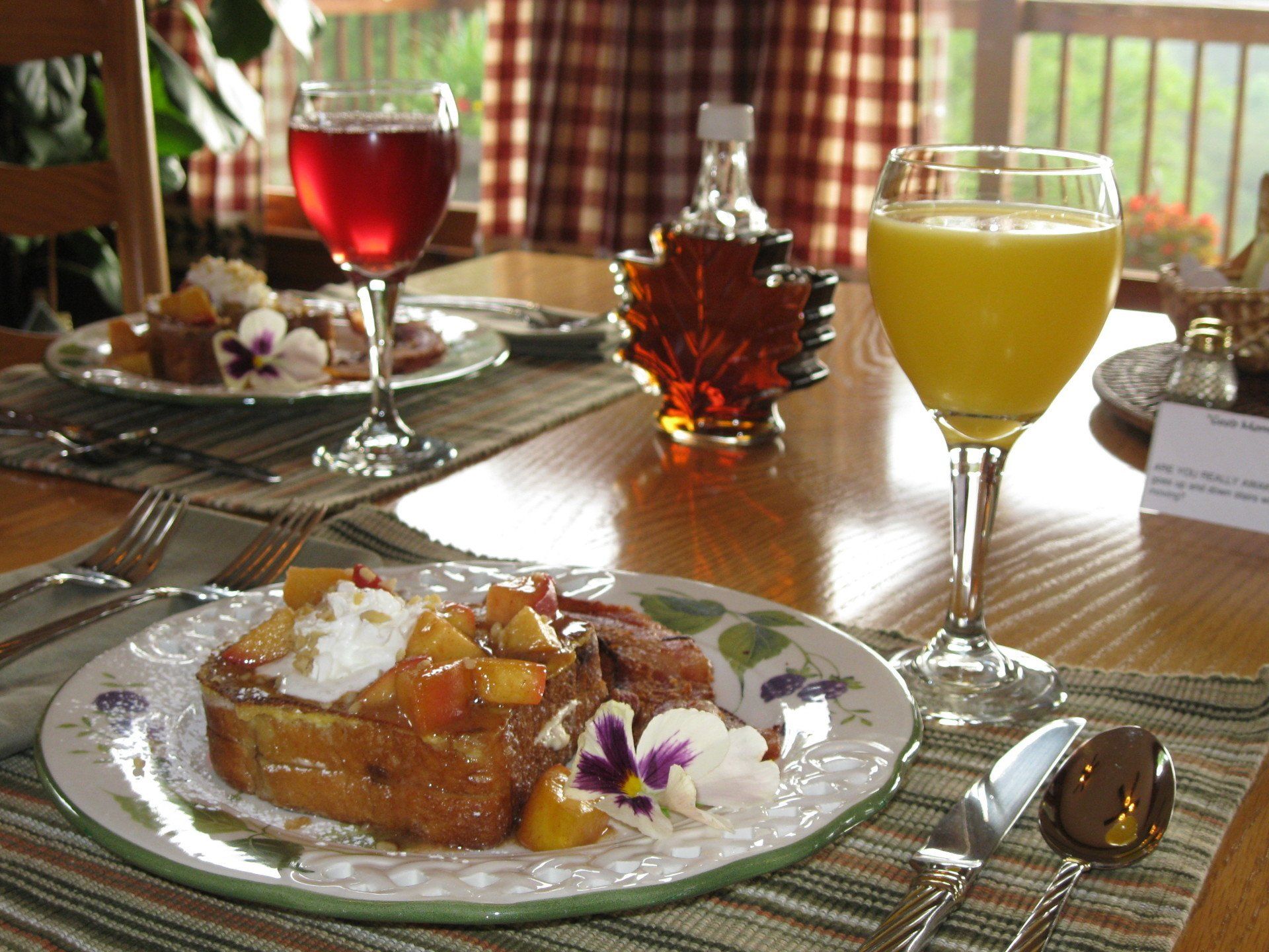 A plate of food and a glass of orange juice on a table