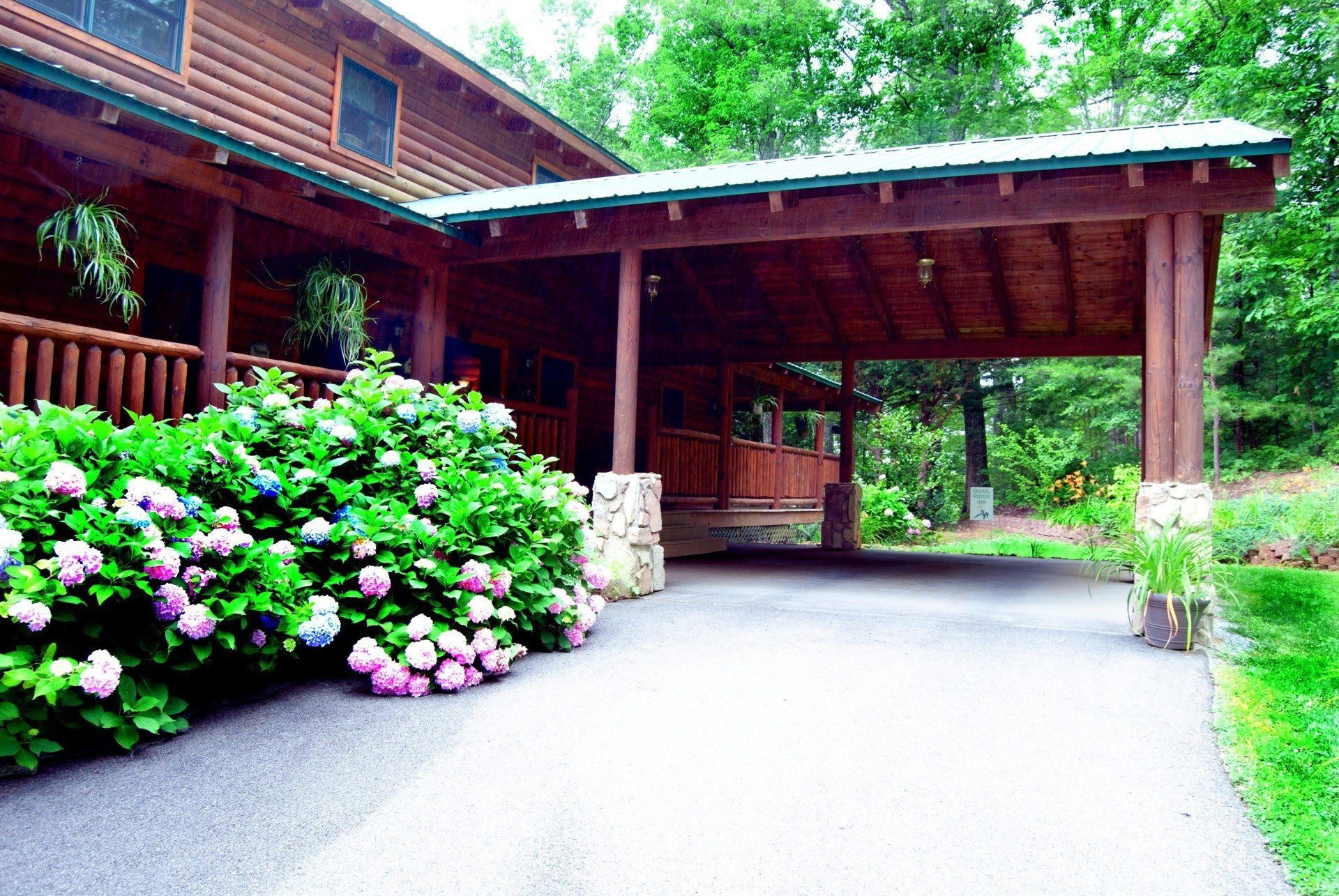 A wooden house with a driveway leading to it