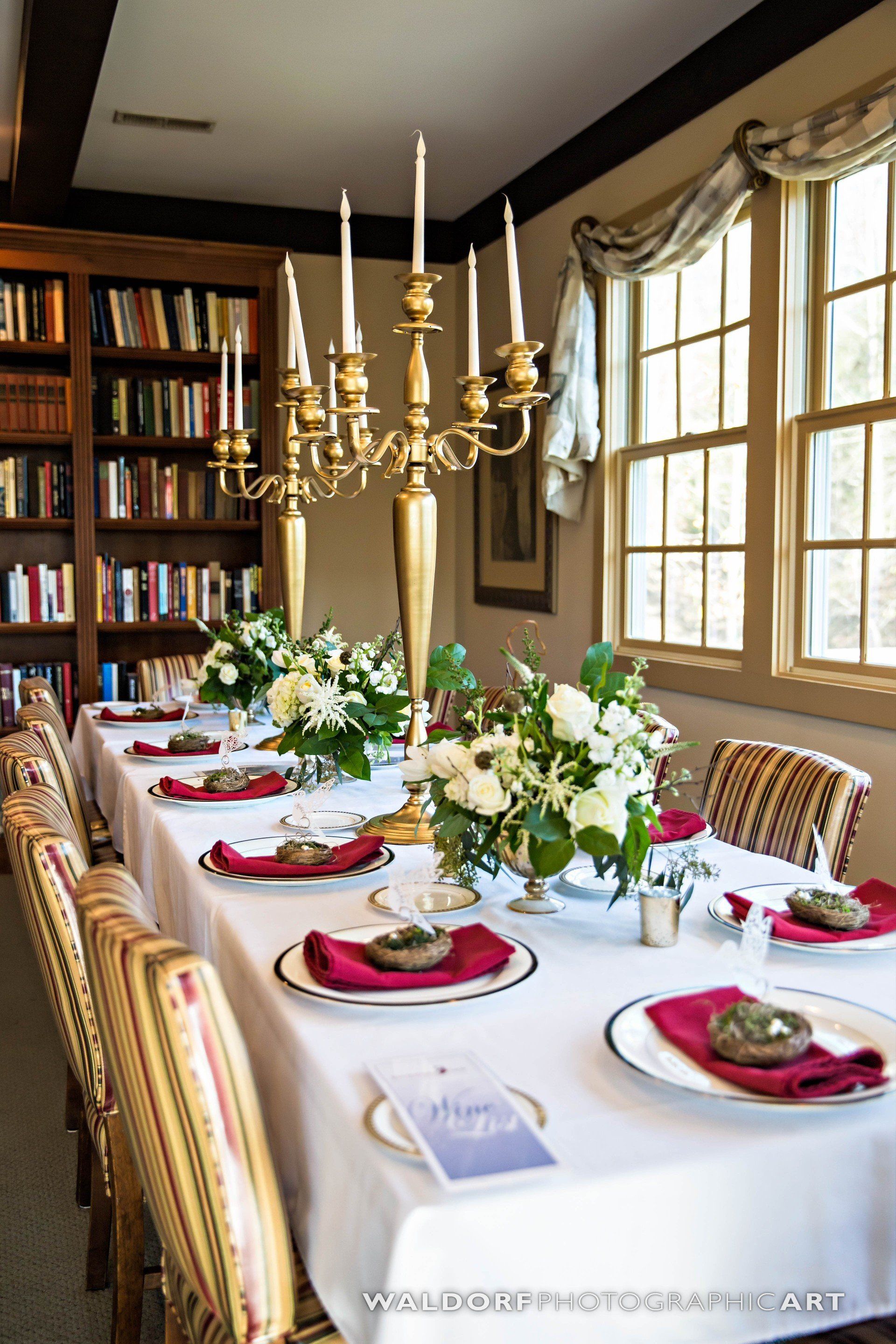A long table with plates and candles on it