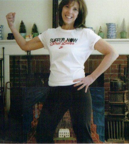 Woman flexing her bicep, wearing a white 