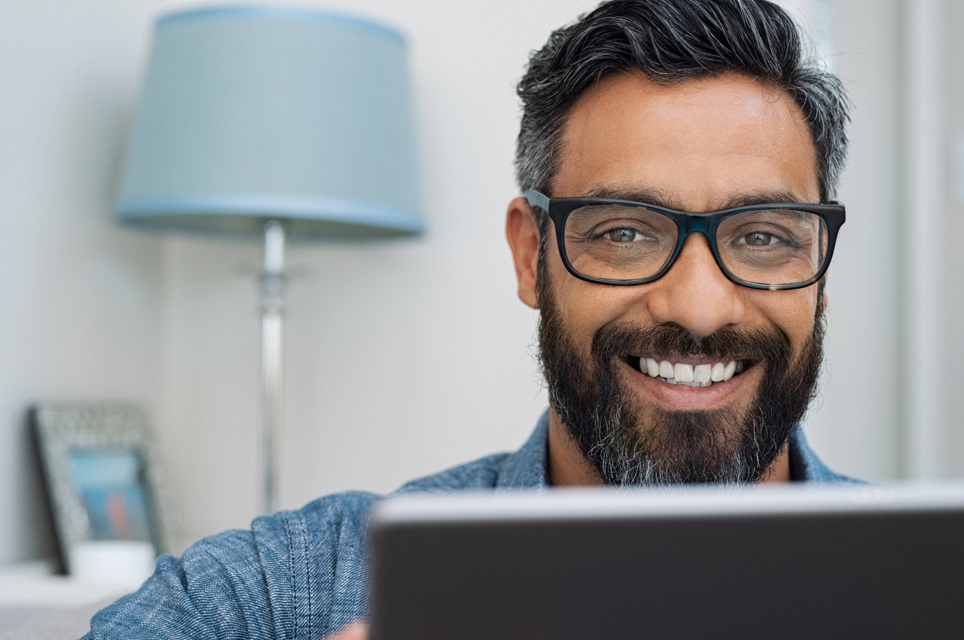 Man in Eyeglass Using Laptop — Clarksville, TN — Carla L. Jones, O.D.