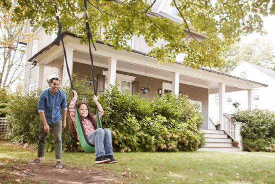 Dad pushing daughter on swing outside home — Vinton, IA — Three Rivers Insurance LLC