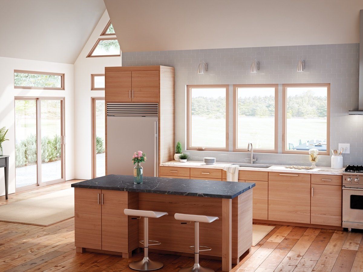 A kitchen with wooden cabinets and a black counter top