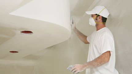 man sanding plasterboard