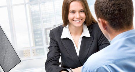 A man talking to a woman in a suit