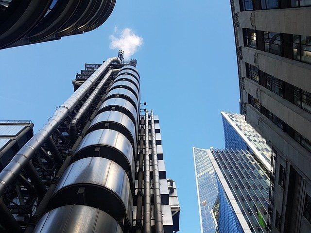 Looking up at a tall building with a blue sky in the background