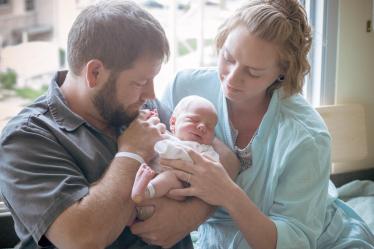 Mother and Father Holding their Child - Photography in Colorado Springs, CO