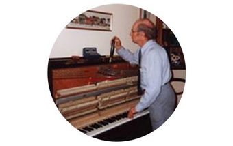 person-fixing-piano person-fixing-piano