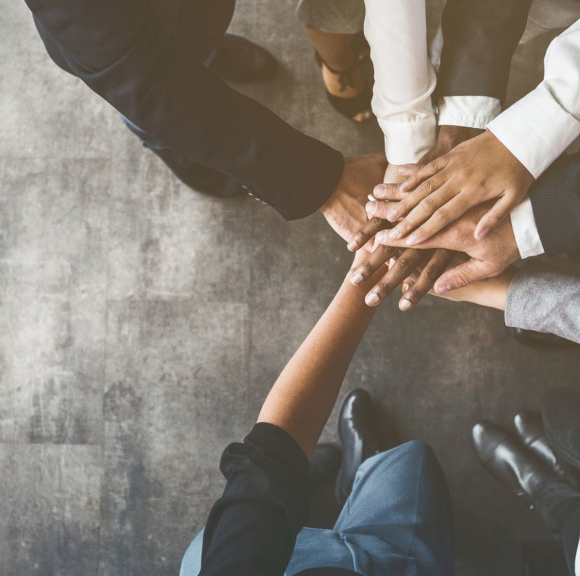 team huddle with hands in the middle