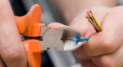 Industrial Electrician — Electrician Cutting Wire in Richardson, TX Industrial Electrician — Electrician Cutting Wire in Richardson, TX