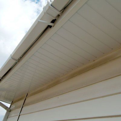 Work in progress on overcladding house soffit board and fascia with renewal of guttering all in plastic materials