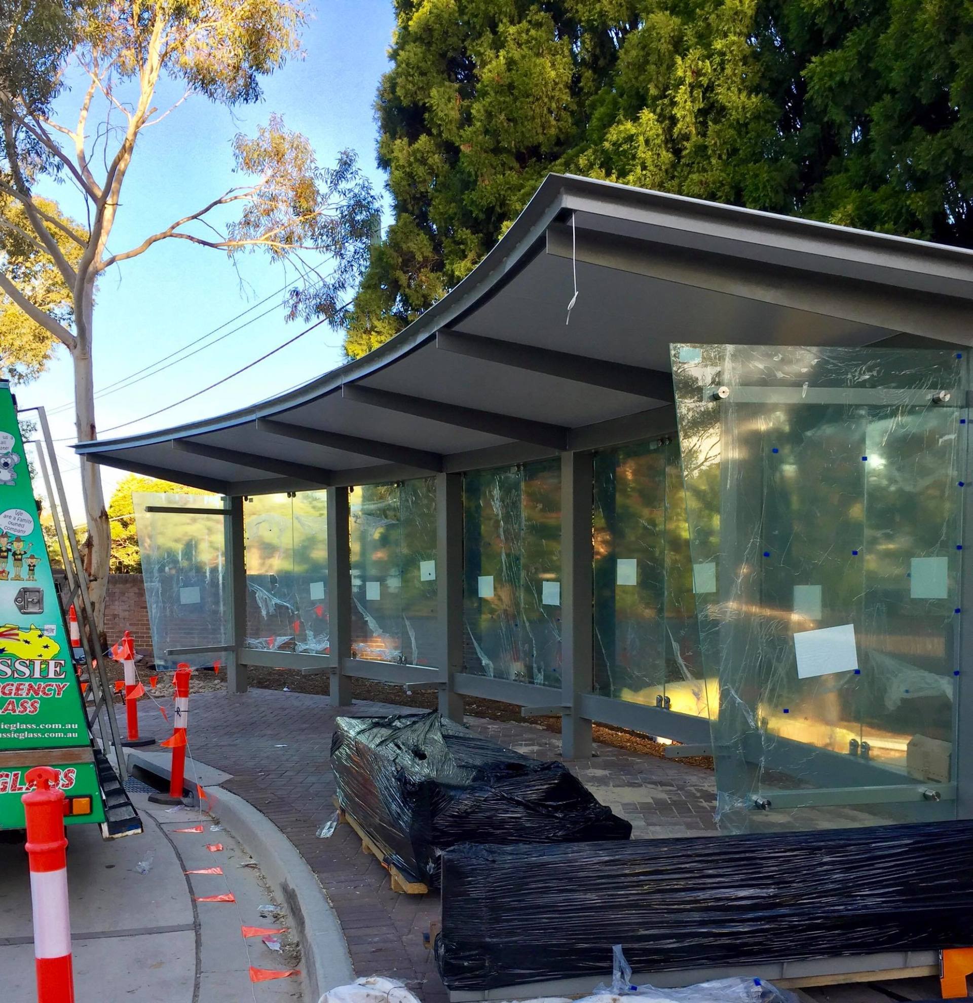 glass at a bus station, highlighting the need for expert glass replacement and repair services.