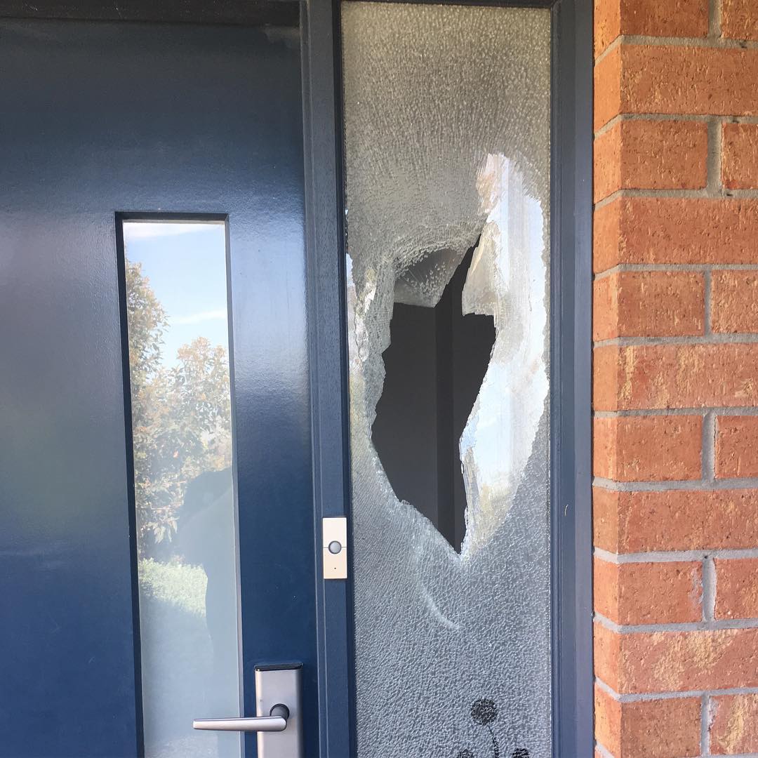 Repairing a broken glass door, with Aussie Emergency Glass offering fast and professional replacement services.