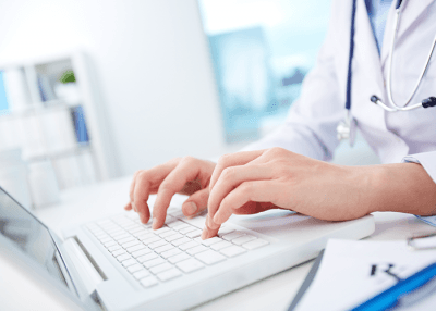 Doctor Typing on Laptop — Arlington, TX — Pronto Courier Delivery and Logistics