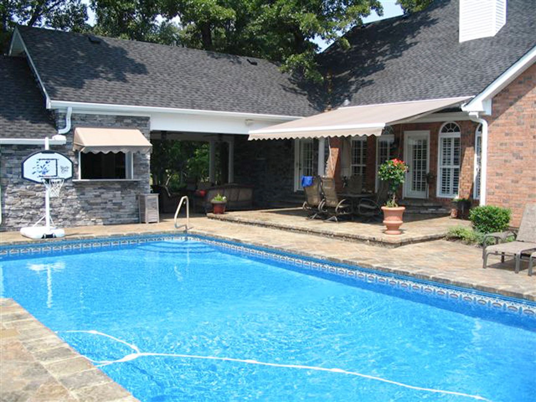 a house with a large swimming pool in front of it