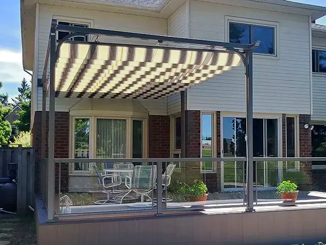 A house with a patio with a striped awning over it.