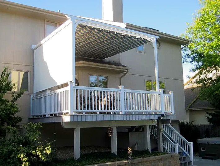 A house with a large deck with a canopy over it