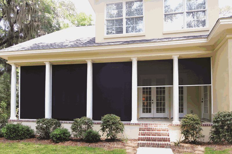 A house with a screened in porch and stairs