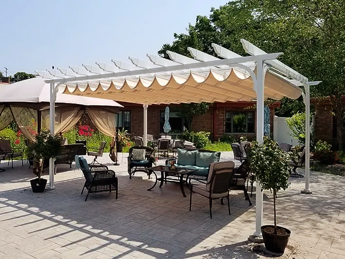 A patio with chairs , tables and umbrellas under a pergola