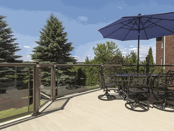 A deck with a table and chairs and a blue umbrella
