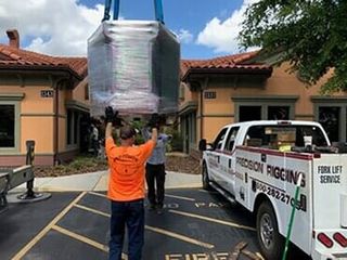 Using Lift to Place Equipment in Truck - Machinery Movers in Tampa, FL Using Lift to Place Equipment in Truck - Machinery Movers in Tampa, FL