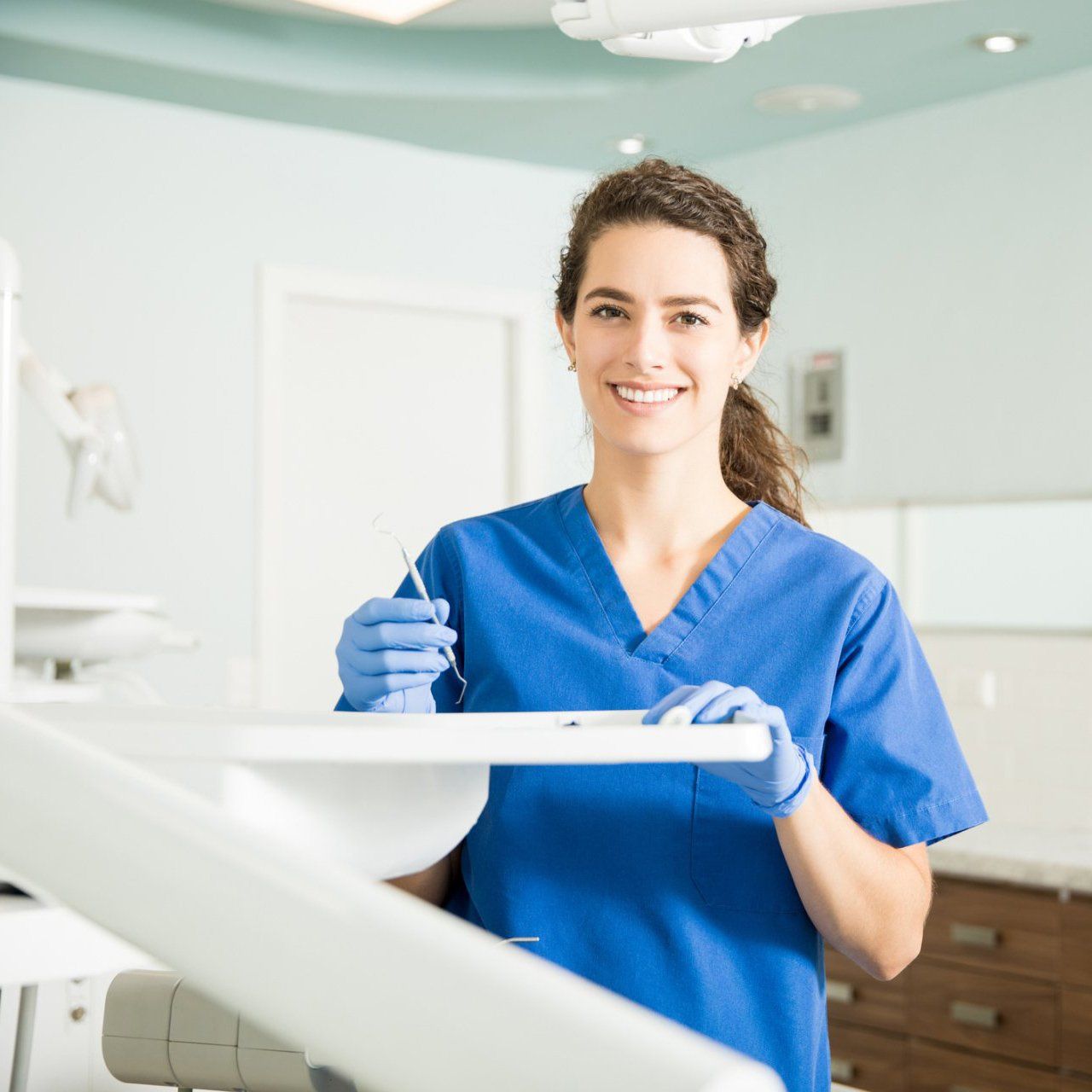Dentist Holding Dental Equipment — Newburyport, MA — Vaka Dental Care Dentist Holding Dental Equipment — Newburyport, MA — Vaka Dental Care