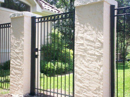 Black Gate Between Rock — San Antonio, TX — Alamo Fence Company of San Antonio, Inc.