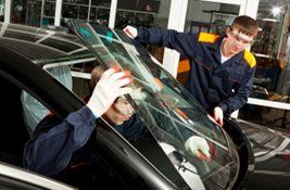 2 people installing windshield