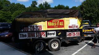 A Jerry Hauls It All trailer is parked in a parking lot
