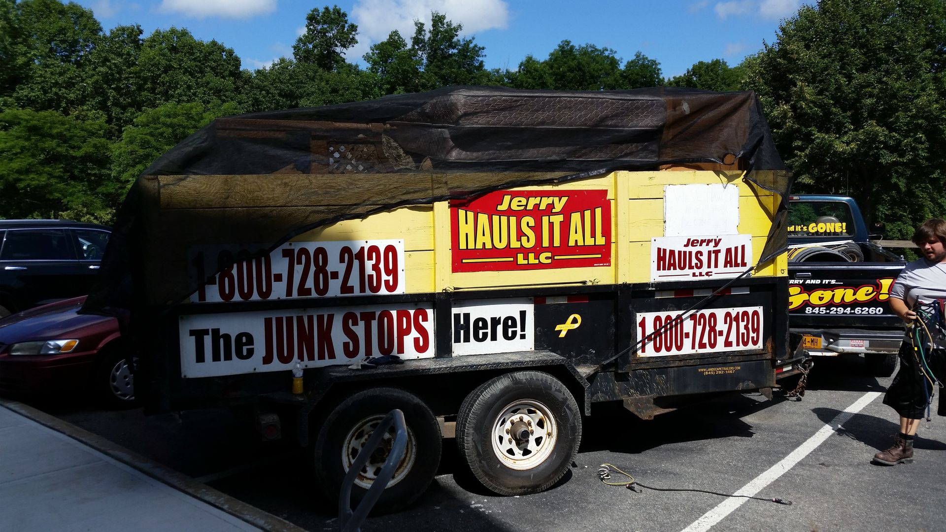 A jerry hauls it all trailer is parked in a parking lot