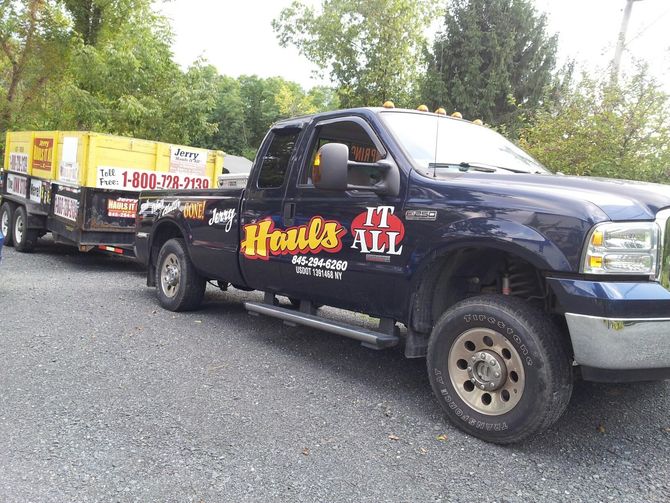 A truck that says Jerry Hauls It All on the side of it